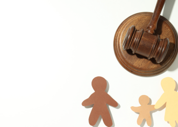 Gavel with paper cutout family, illustrating family law.