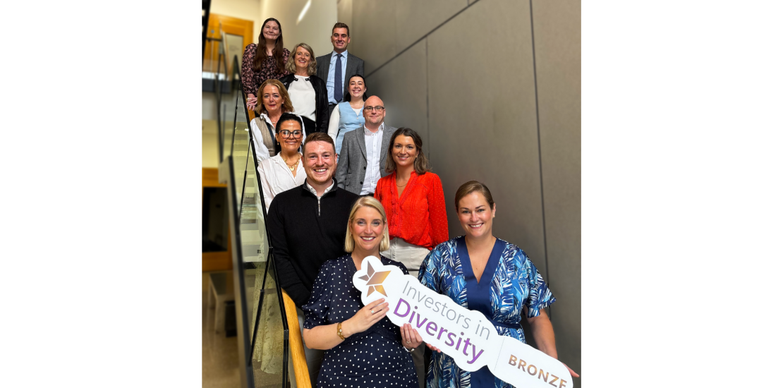 CKT staff holding Investors in Diversity Bronze award sign