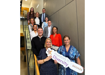 CKT staff holding Investors in Diversity Bronze award sign