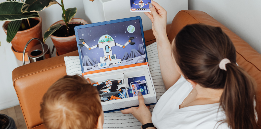 Mother showing child a spaceperson card
