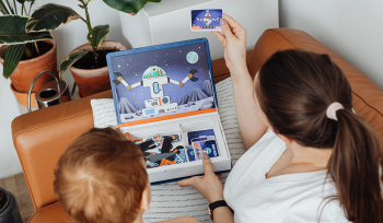 Mother showing child a spaceperson card